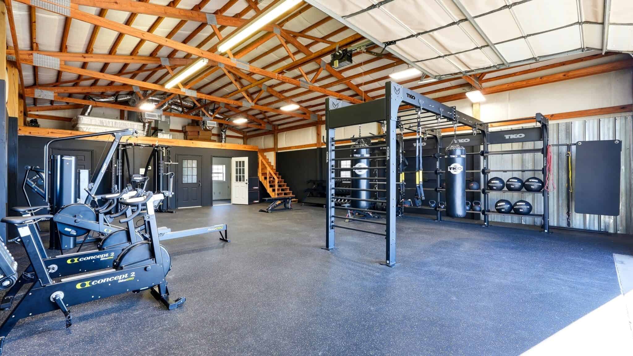Modern gym with fitness equipment and functional training area at pH Wellness.