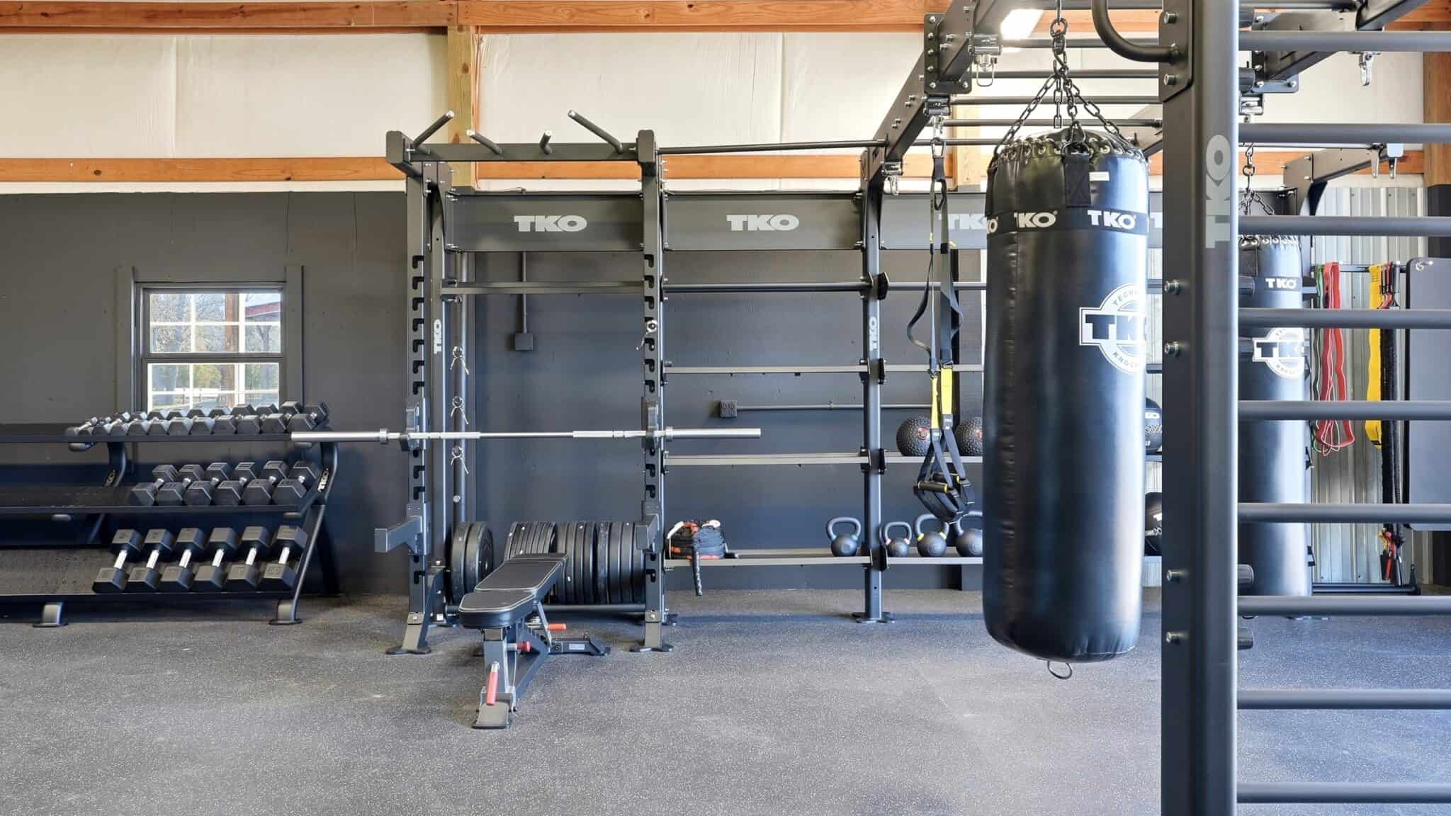 Modern gym with weightlifting and boxing equipment at pH Wellness.