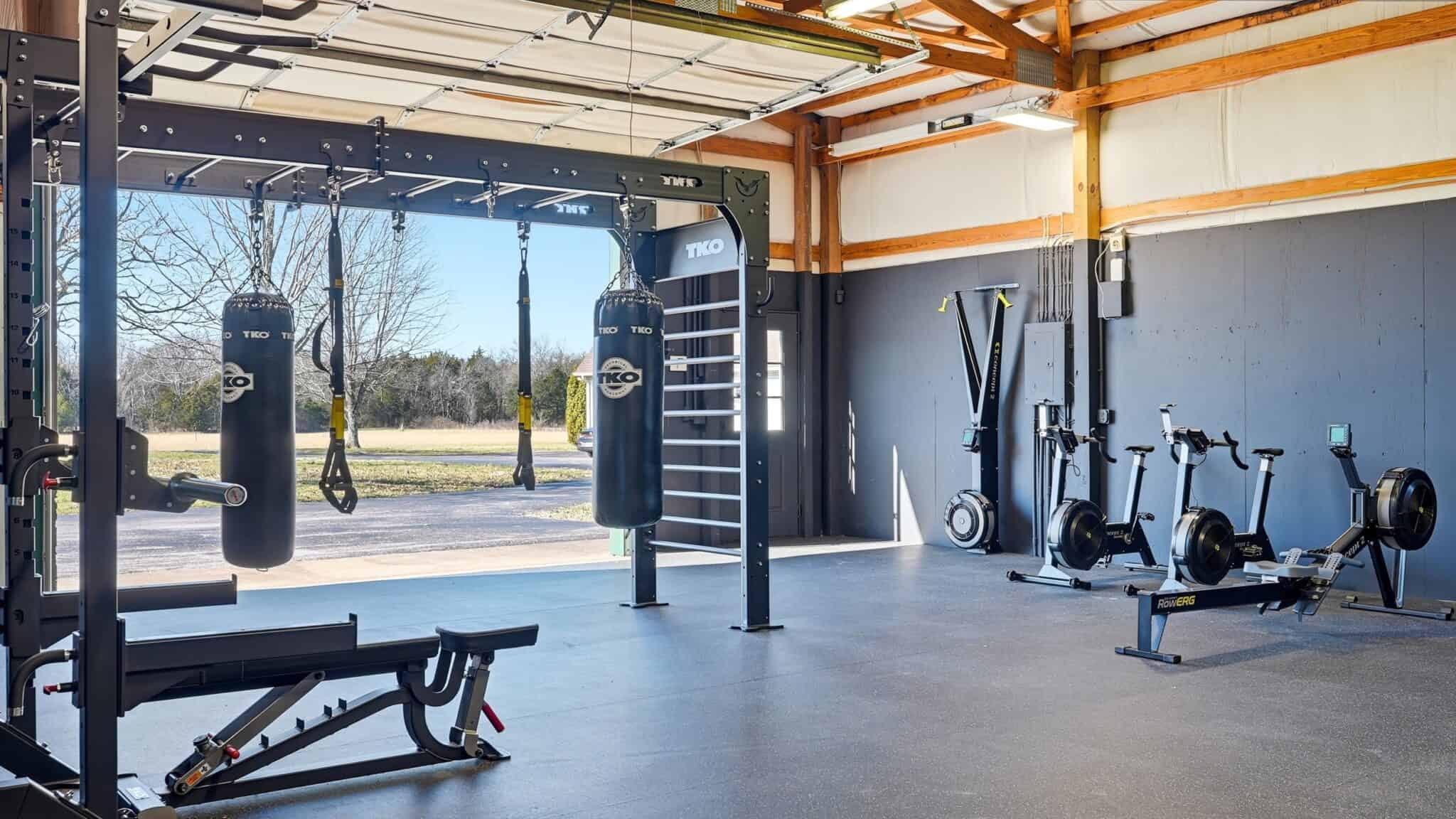 Modern gym with boxing bags, rowing machines, and workout equipment at pH Wellness.