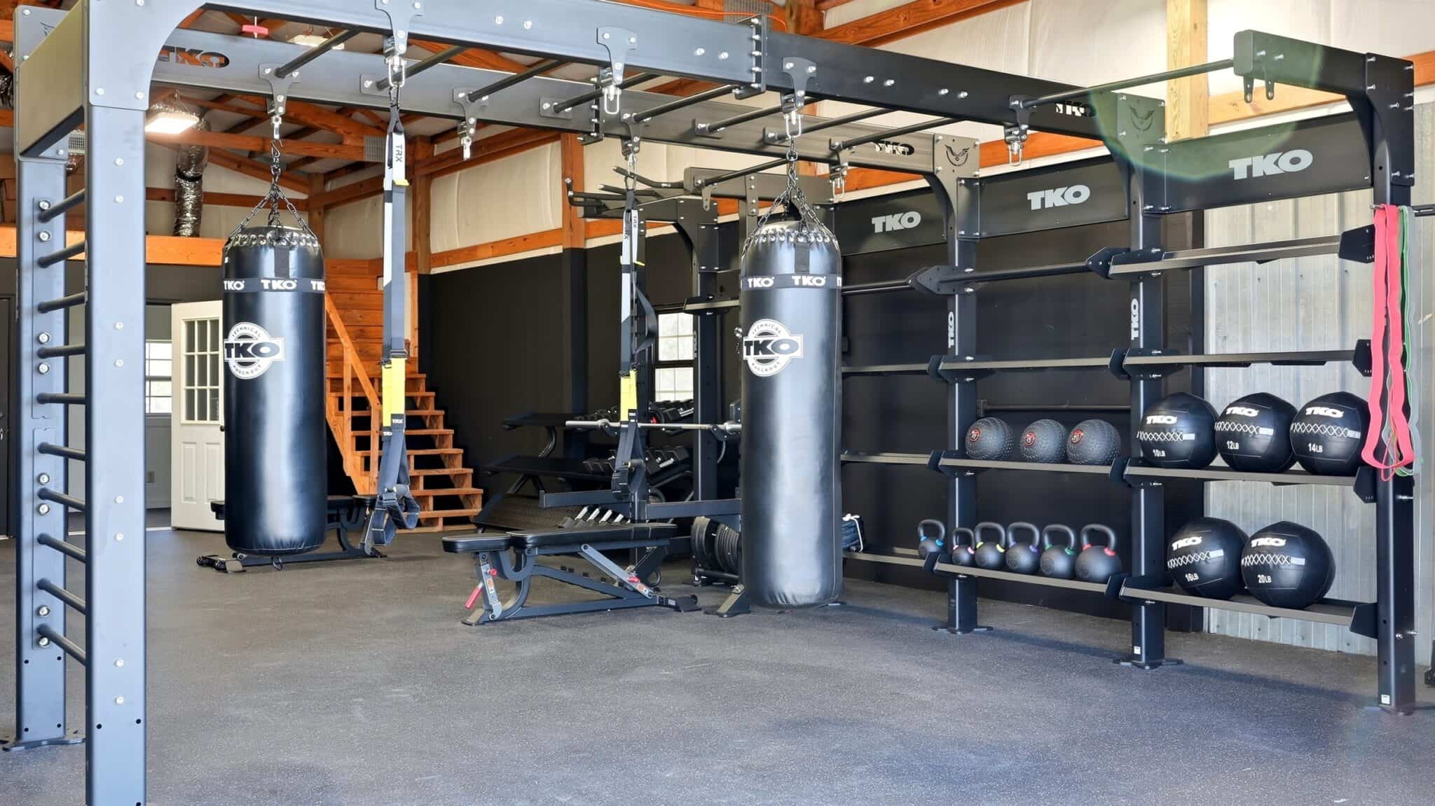Modern gym with boxing bags, kettlebells, and workout equipment at pH Wellness.